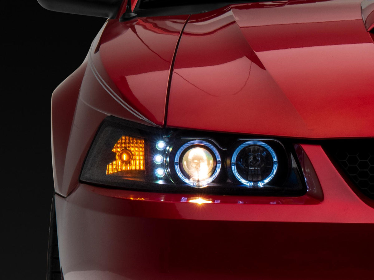 Raxiom 99-04 Ford Mustang Dual LED Halo Projector Headlights- Black Housing (Clear Lens) - 101684